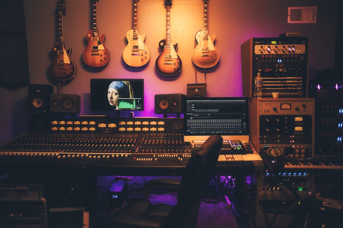 Professional beatmaker working on kompa music production in a DAW studio setup with monitors and MIDI keyboard