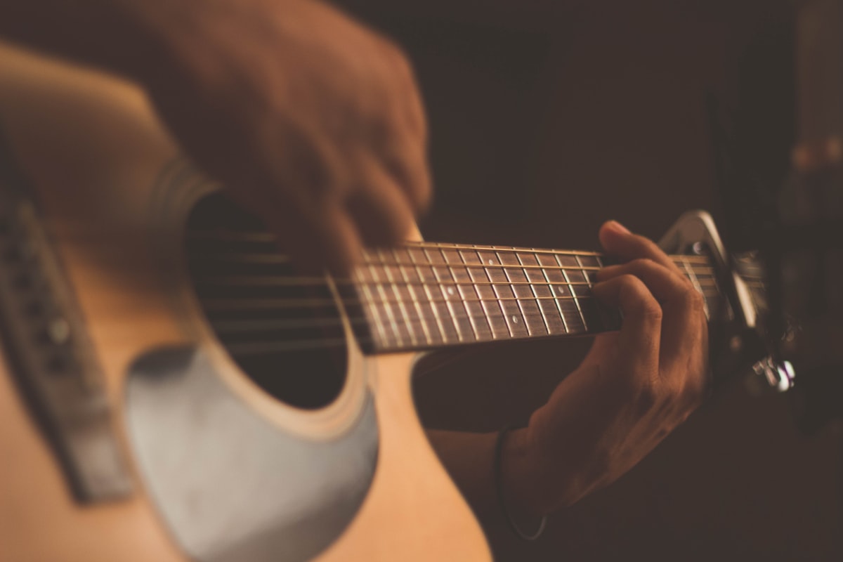 Caribbean musician playing guitar — the rhythmic guitar chord stab is a signature element of authentic kompa music production