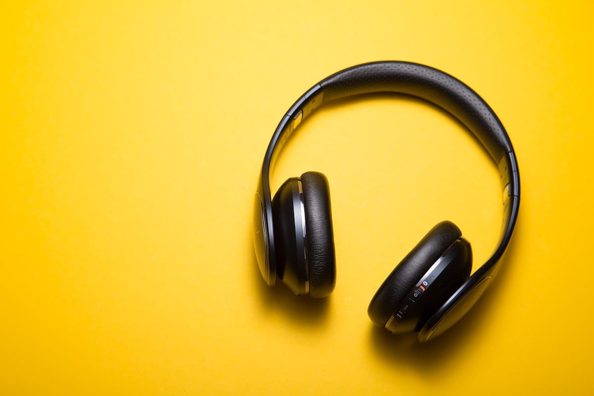 Music producer wearing headphones ready to use free caribbean drum kit samples in their DAW